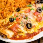Cheesy Chicken Enchilada on plate with a side of Mexican rice