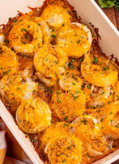 Cheesy Tennessee Onions on a casserole pan on wooden table