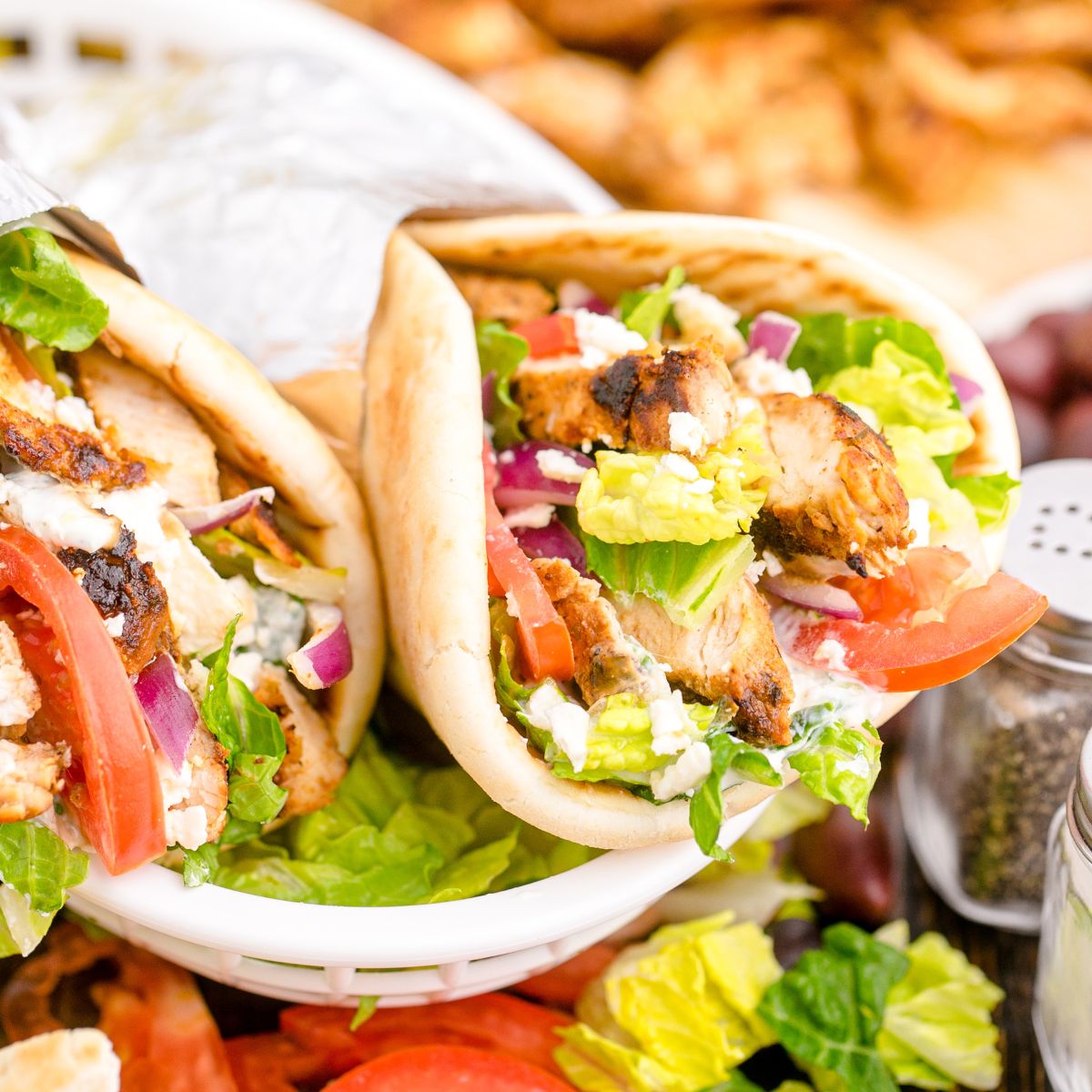 Chicken Gyros are in a platter with more ingredients around them