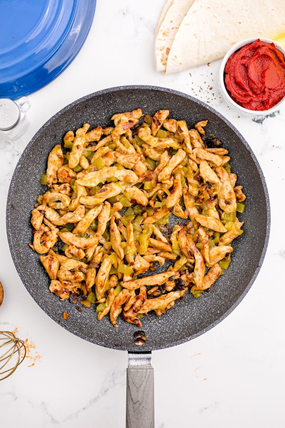 skillet seared chicken in  a pan sitting on table 