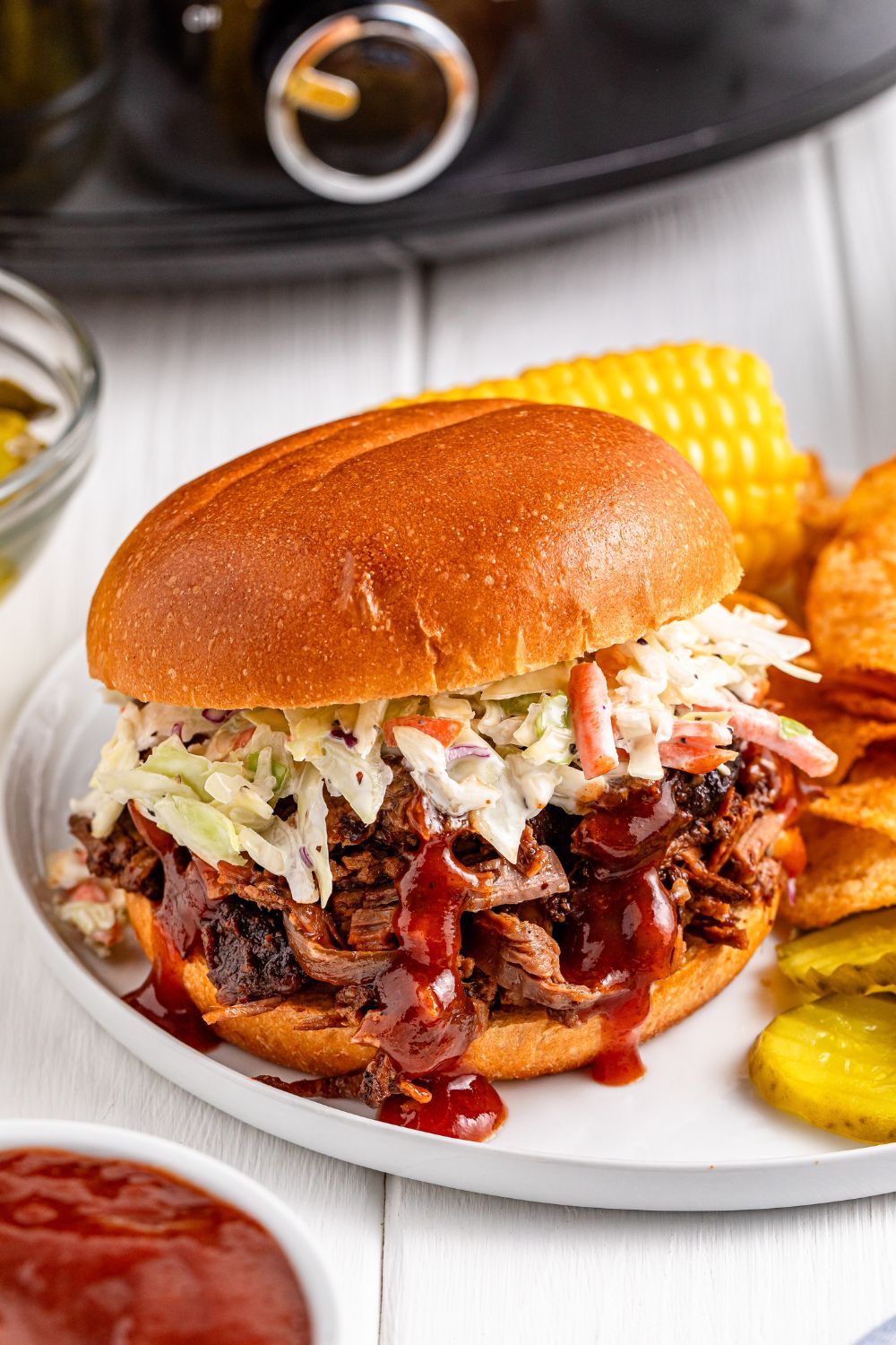 brisket sandwich on plate topped with coleslaw