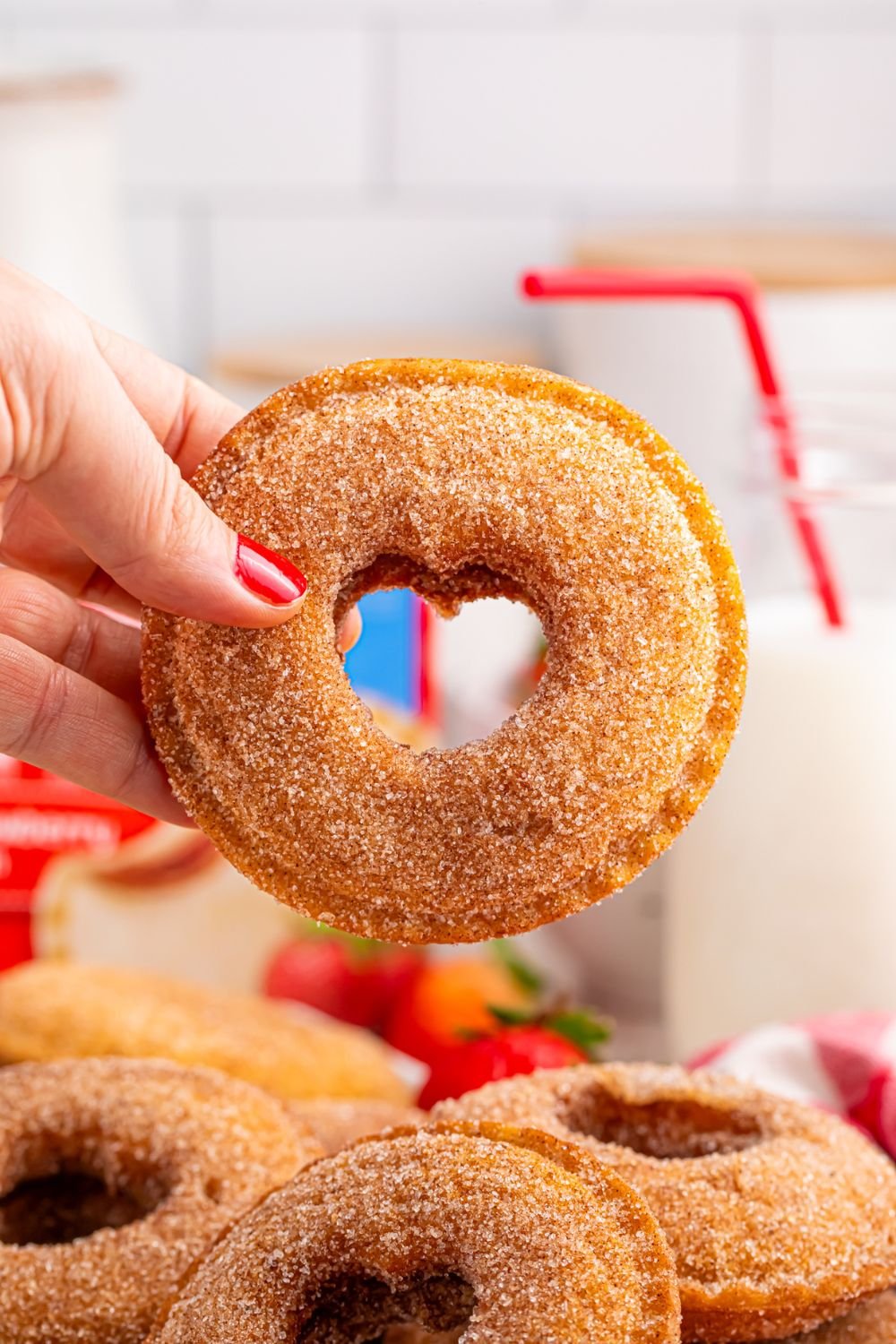 hand holding a Fried Strawberry Uncrustable with heart cut out in center 