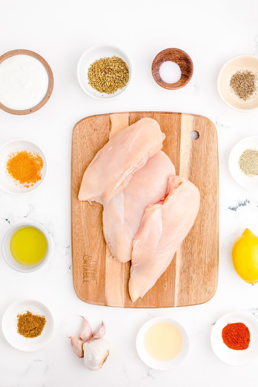 ingredients for chicken gyros on table in single serve bowls 