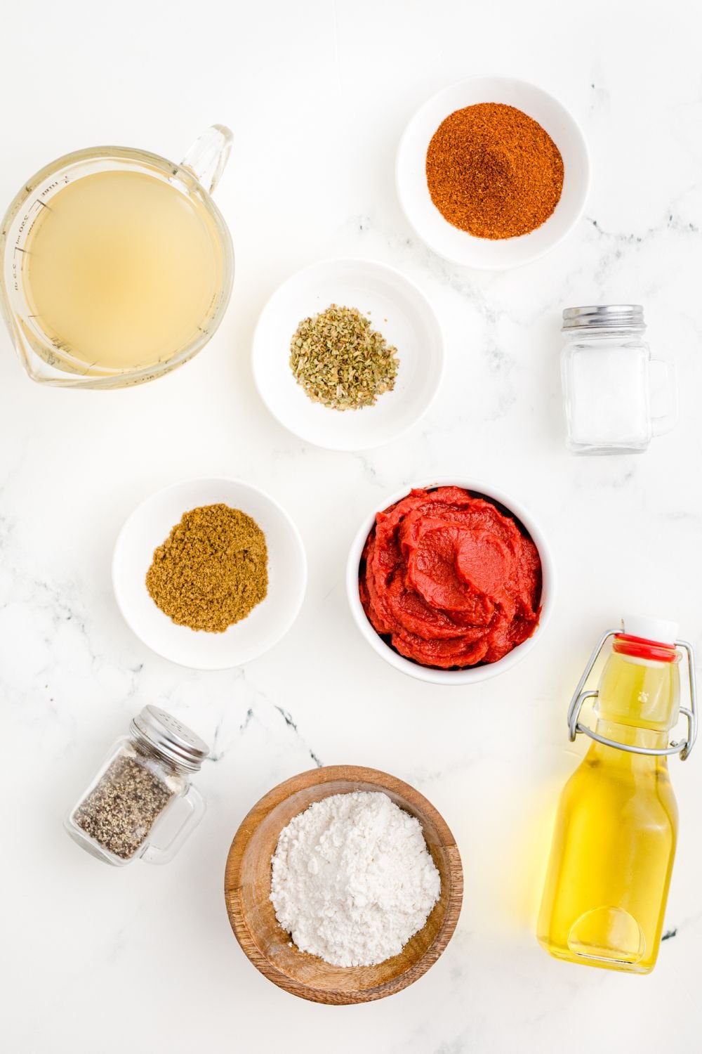 ingredients for Homemade Enchilada Sauce in single serve bowls on table 