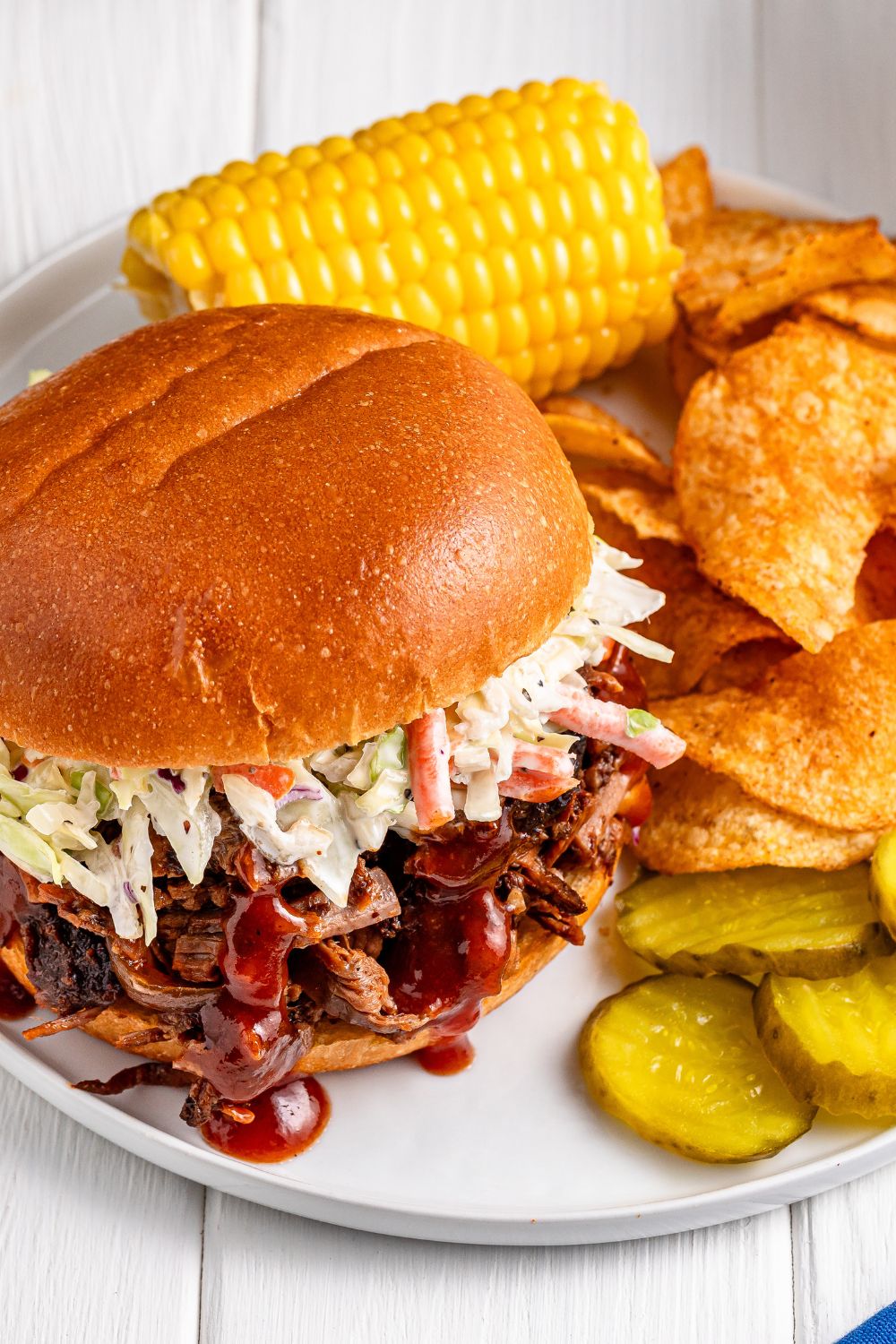 overhead look of plate with a brisket sandwich and sides 