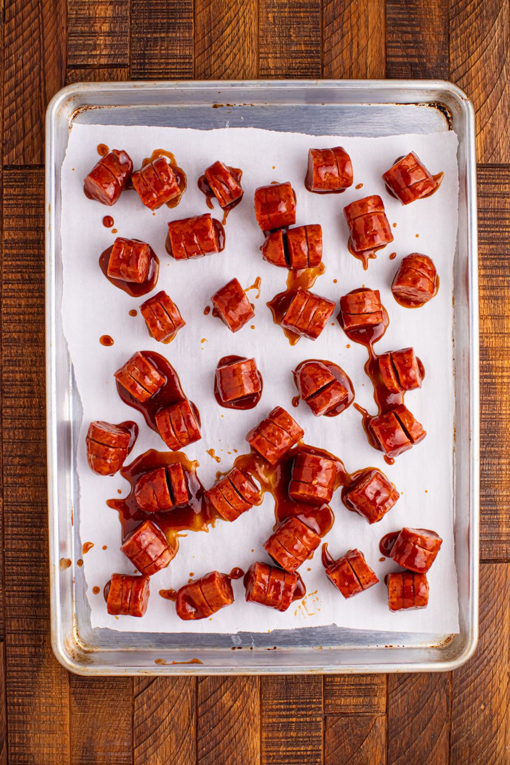 BBQ Hasselback Smoked Sausages on baking tray 