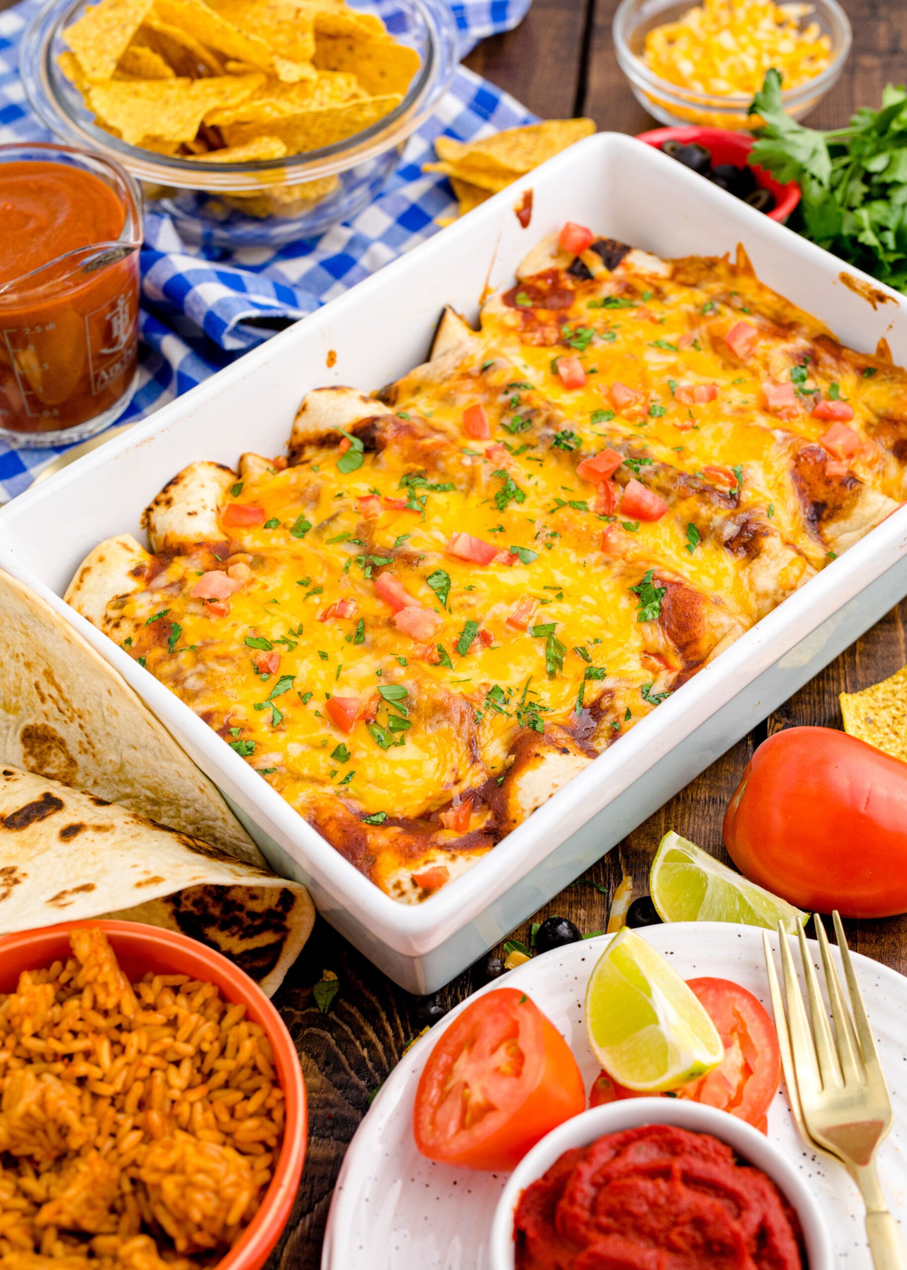 Cheesy Chicken Enchiladas in a white baking pan