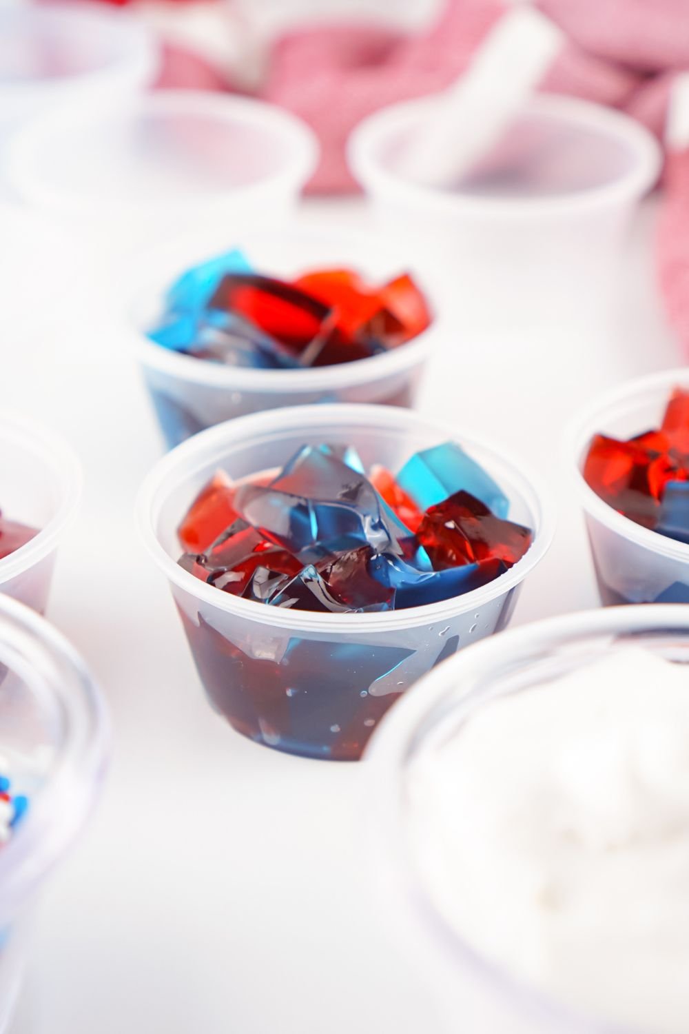 cubed red and blue jello in jello shot containers 