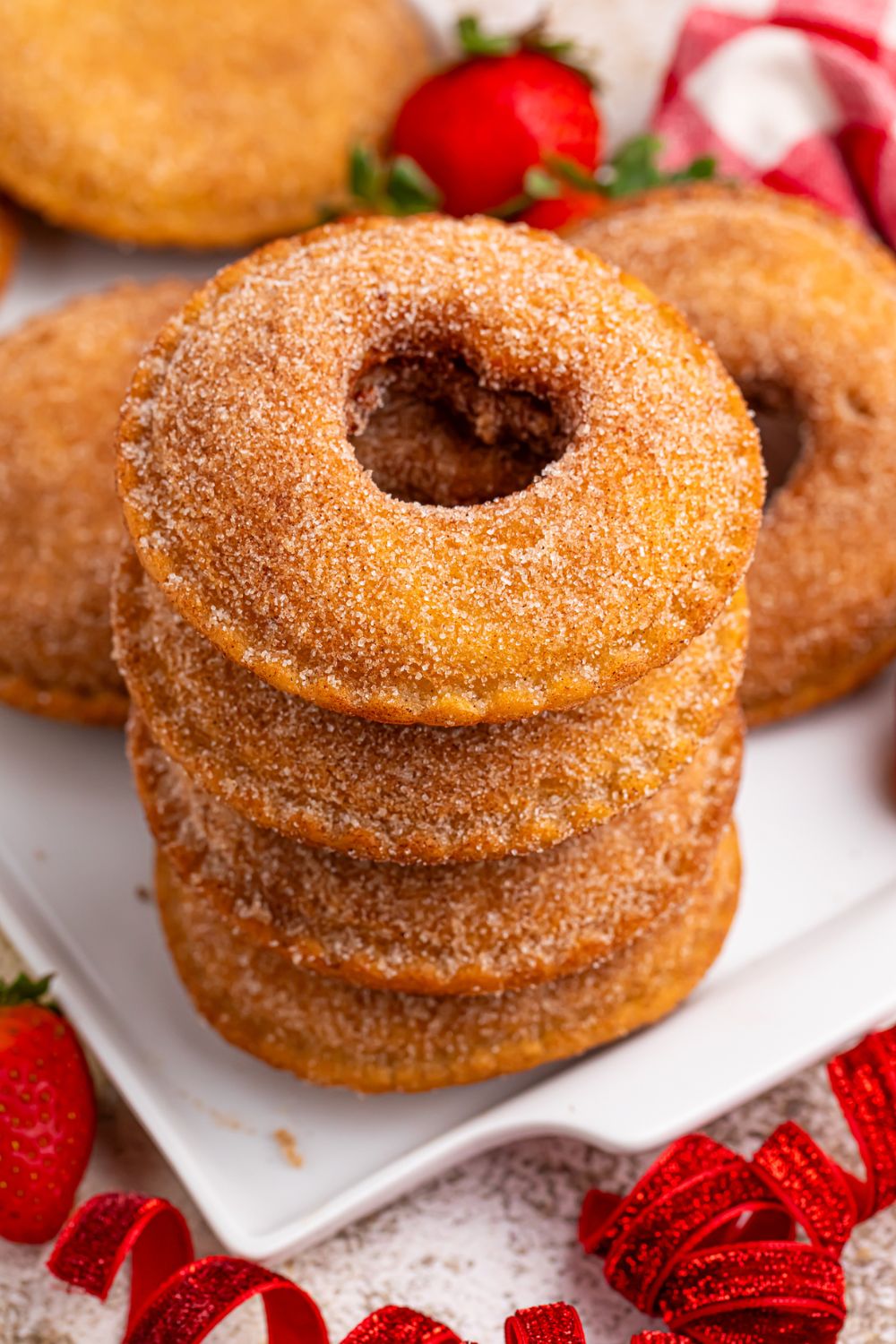 Fried Strawberry Uncrustables stacked on plate in a tower 