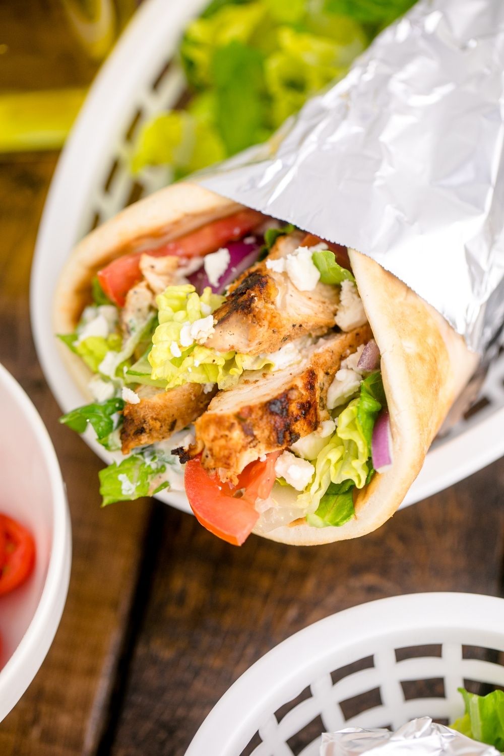 close up look of a chicken gyro wrap in a food basket