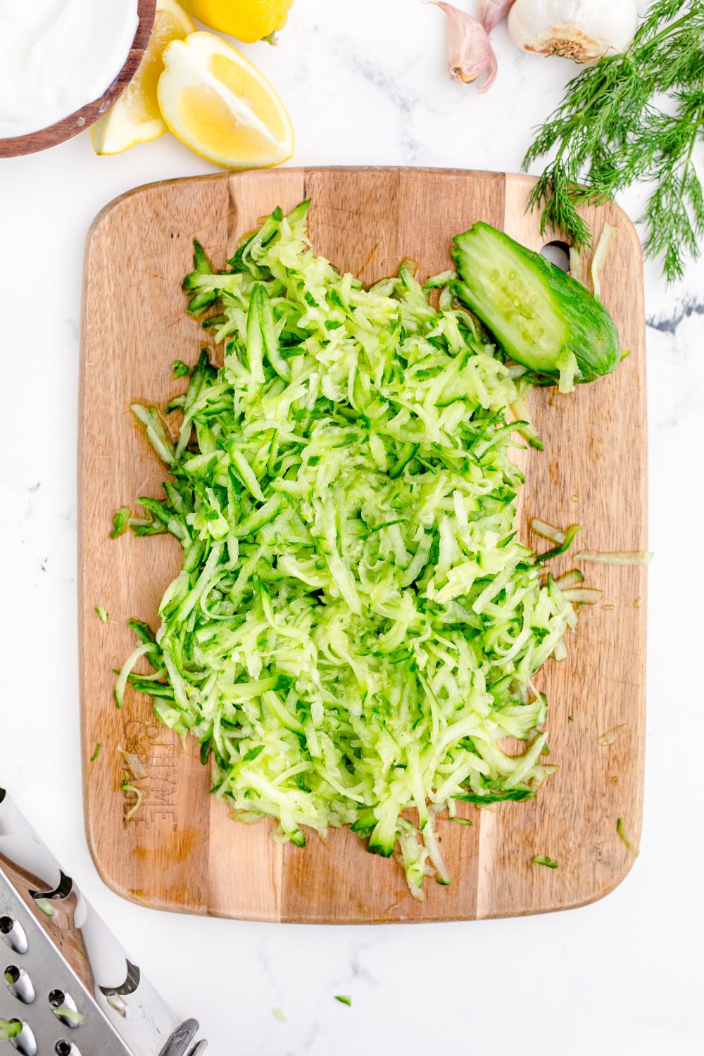 shredded cucumbers on a cutting board 