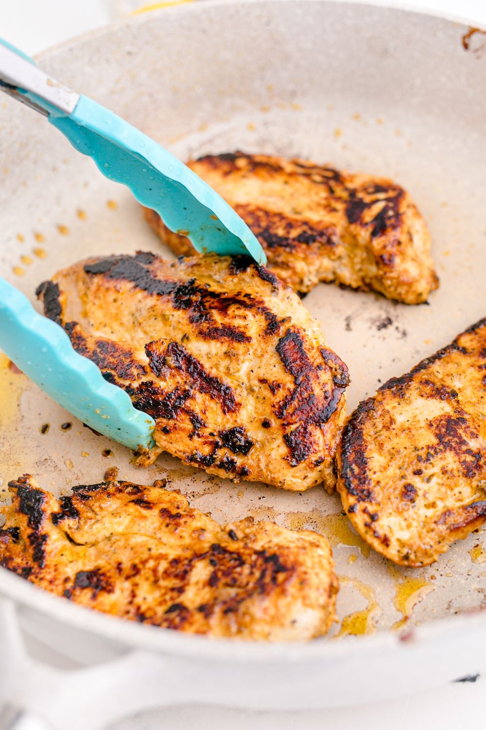 chicken being cooked in skillet