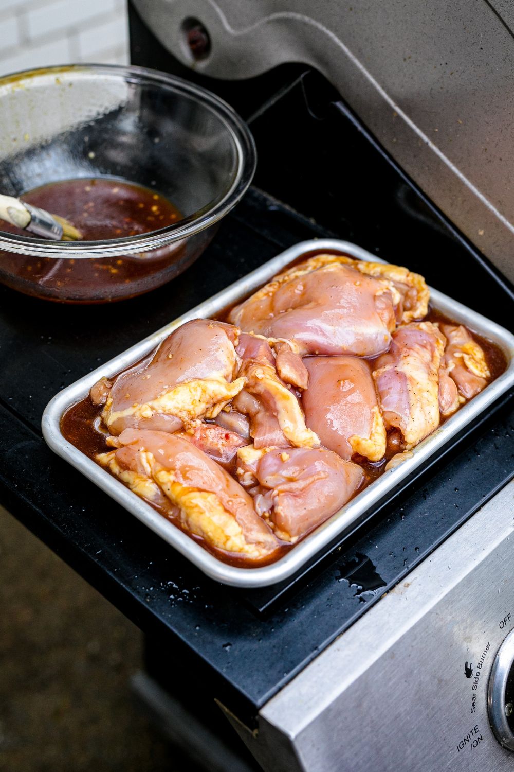marinated chicken in a pan on grill tray