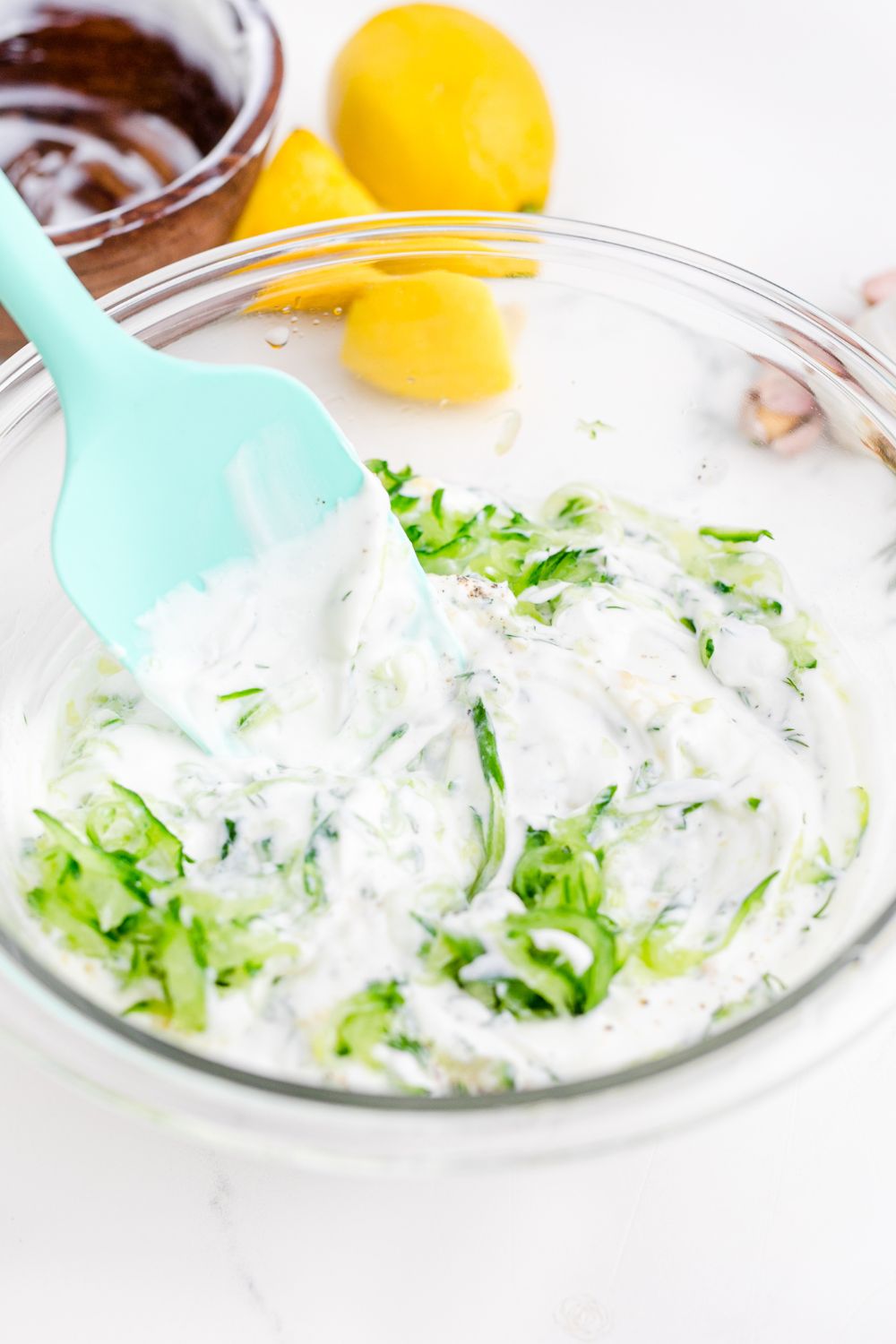 mixing up Tzatziki Sauce in a bowl 