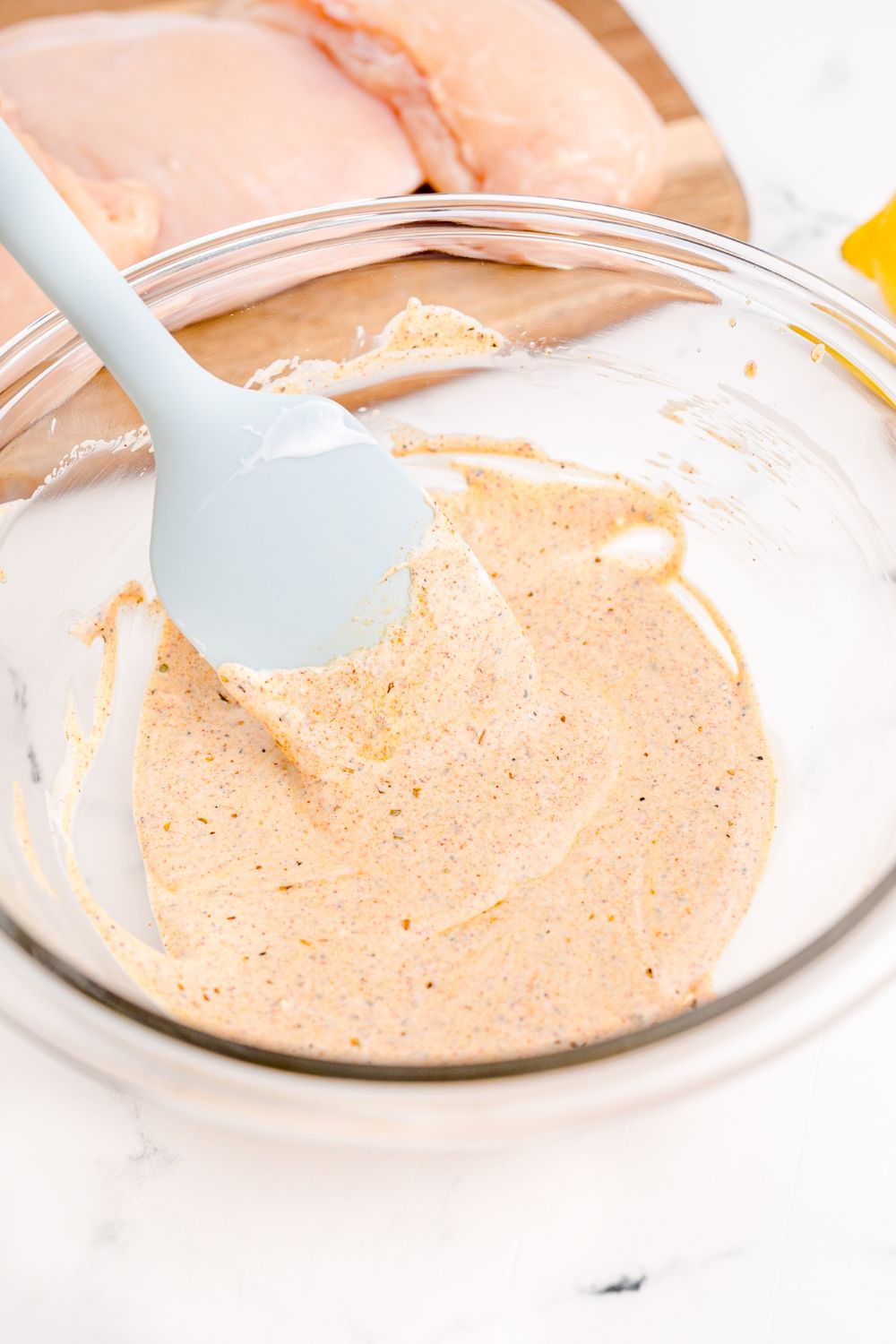 sauce in a bowl with spatula in it on table