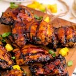 Huli Huli Chicken on a cutting board with pineapple on table