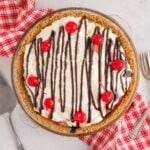 No Bake Banana Split Pie sitting on table with a napkin under it