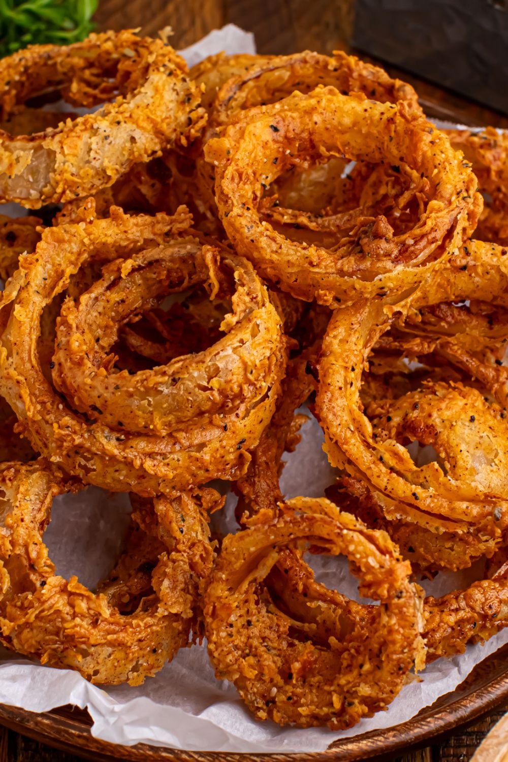 Homemade Deep Fried Onion Rings in a bowl on table 