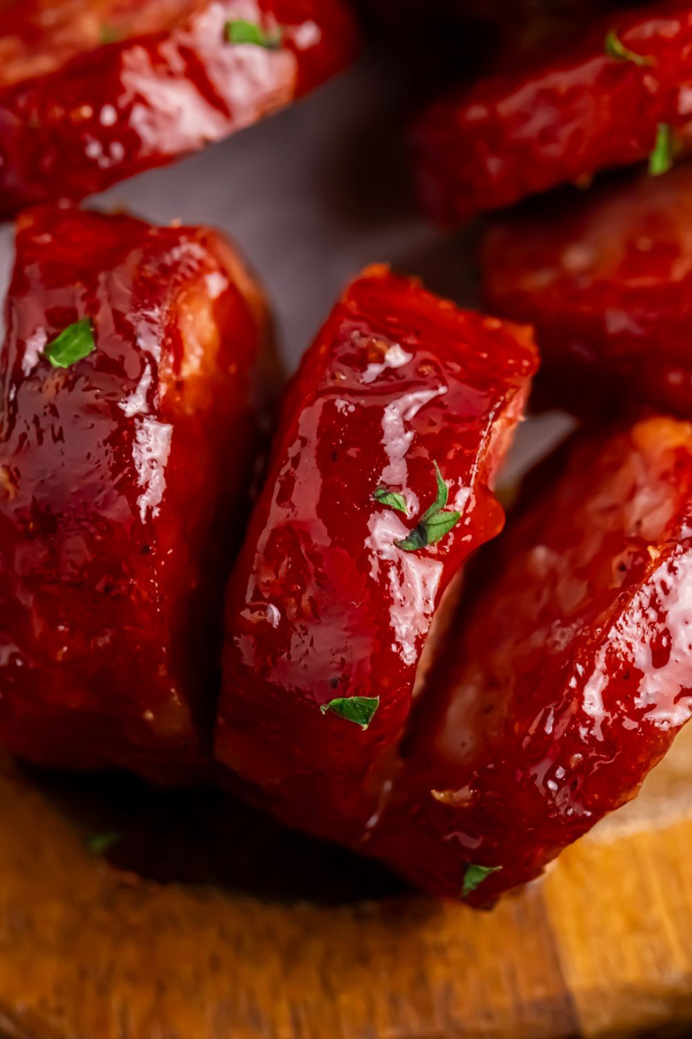 close up of BBQ Hasselback Smoked Sausages on table to see the cuts on the meat 