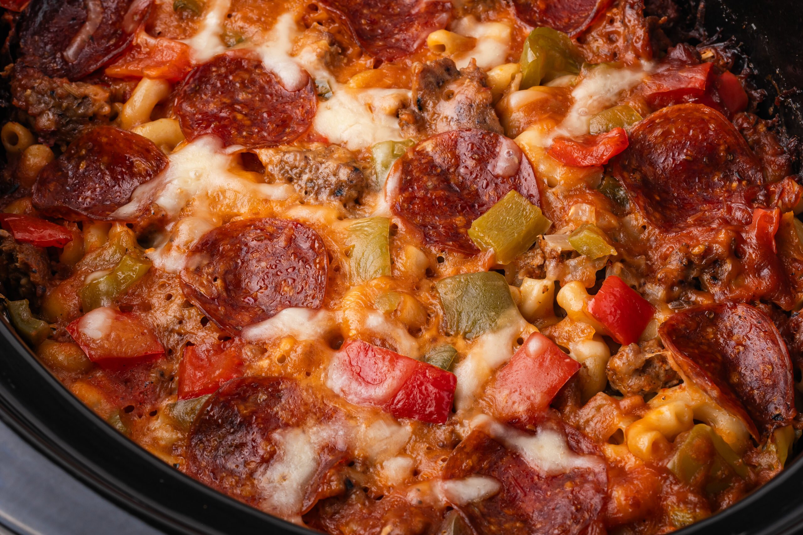 Slow Cooker Pizza Casserole up close showing the toppings