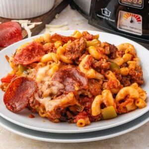 Pizza Casserole on a plate with slow cooker behind it