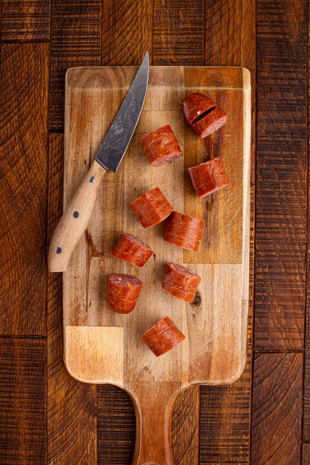 sliced BBQ Hasselback Smoked Sausages on a cutting board 