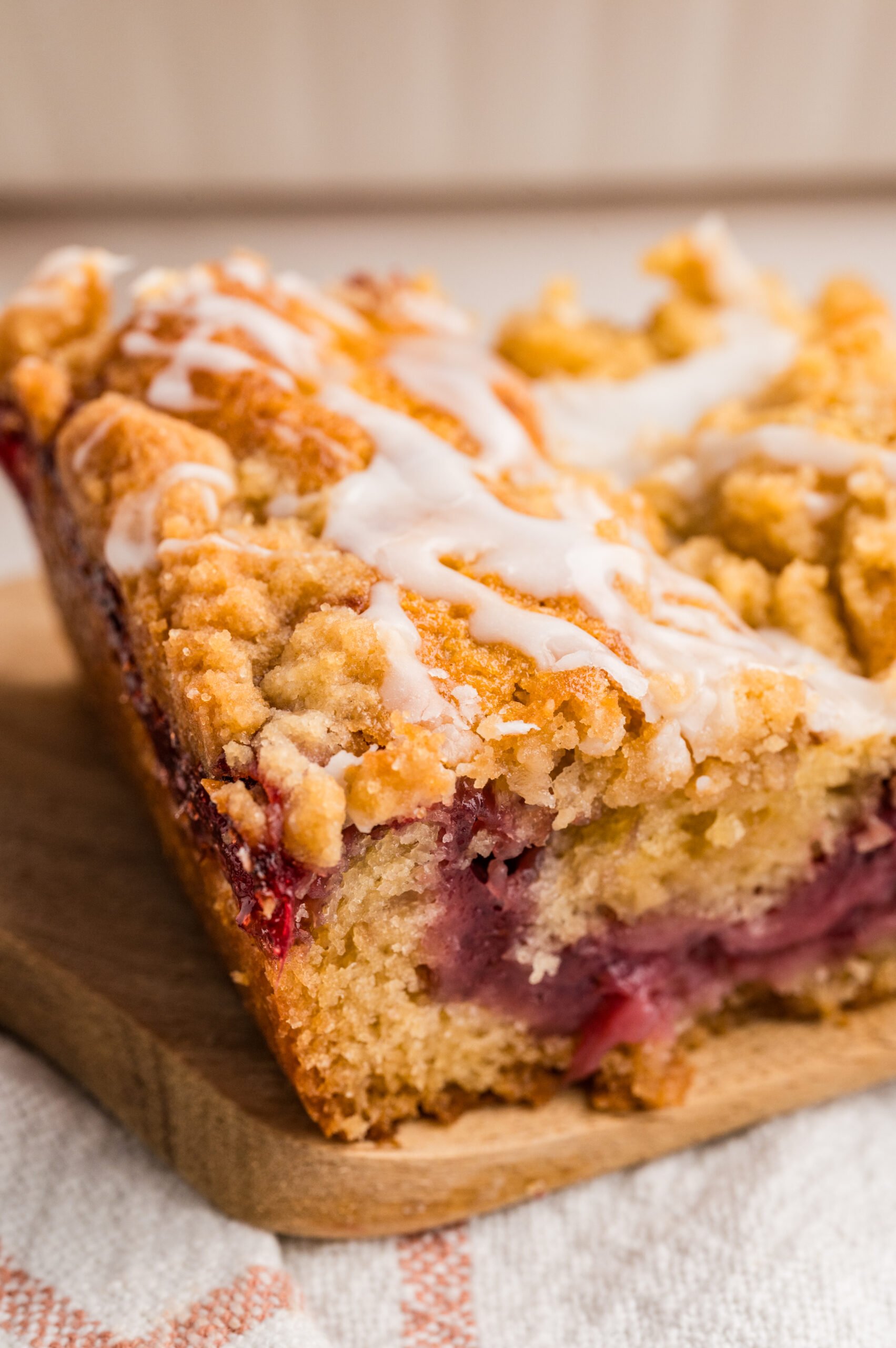 Strawberry Coffee Cake slice on a wooden cutting board