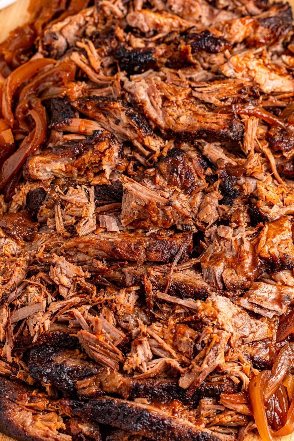 close up of brisket shredded on a cutting board