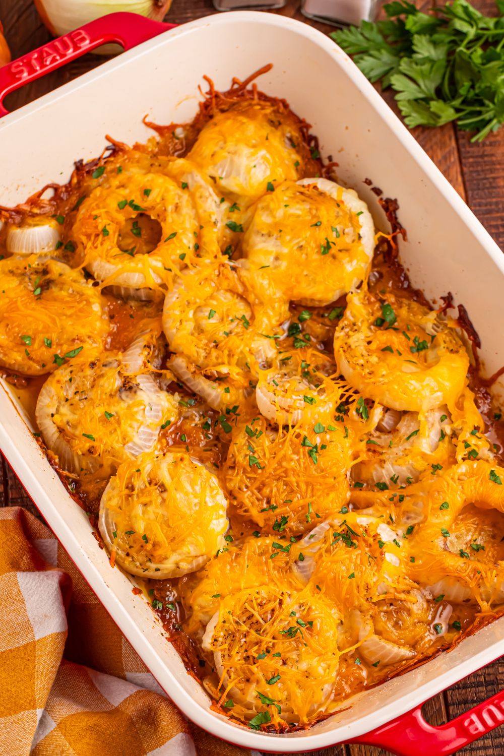 Cheesy Tennessee Onions in a casserole dish sprinkled with parsley on top 