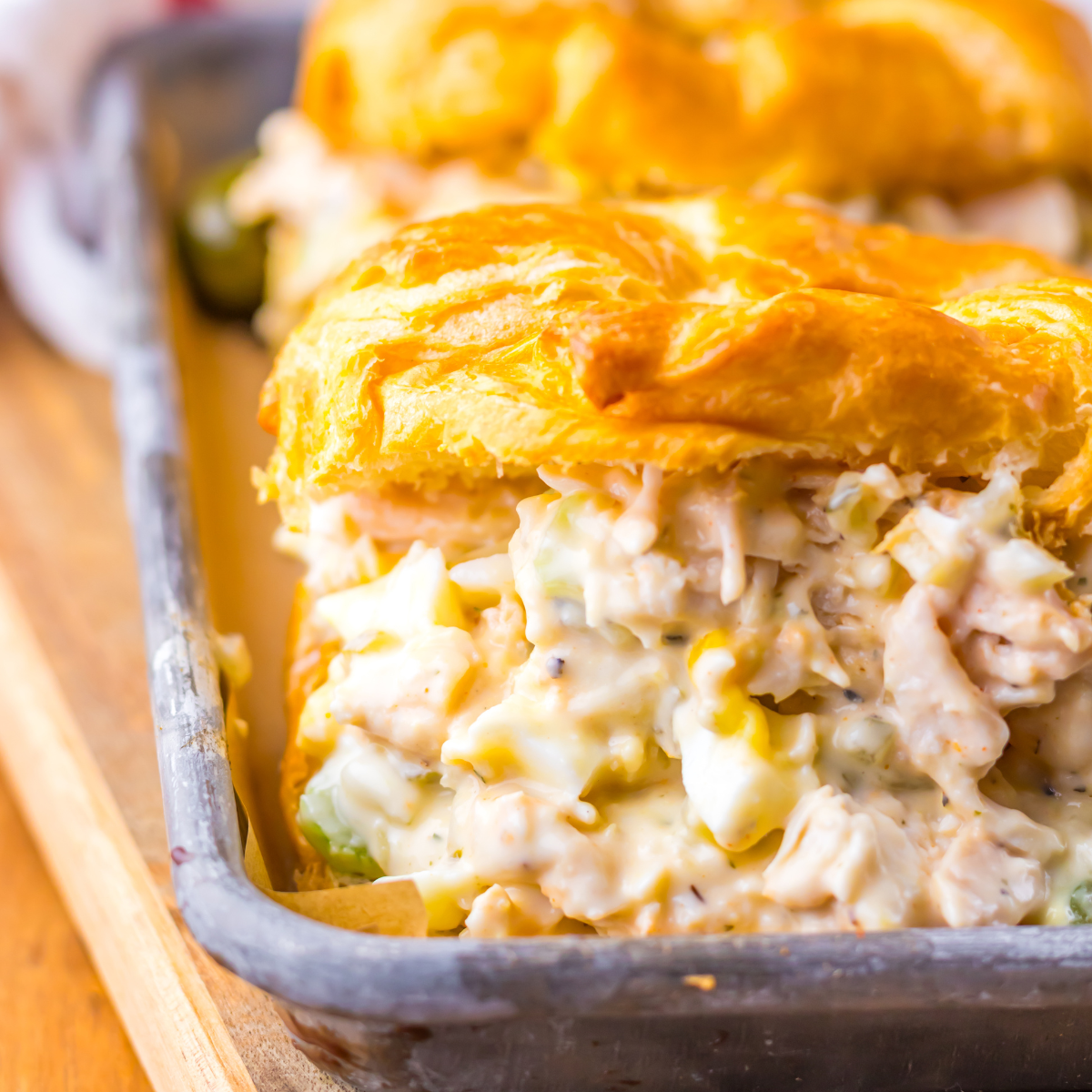 Close up view of a chicken salad stuffed croissant. 