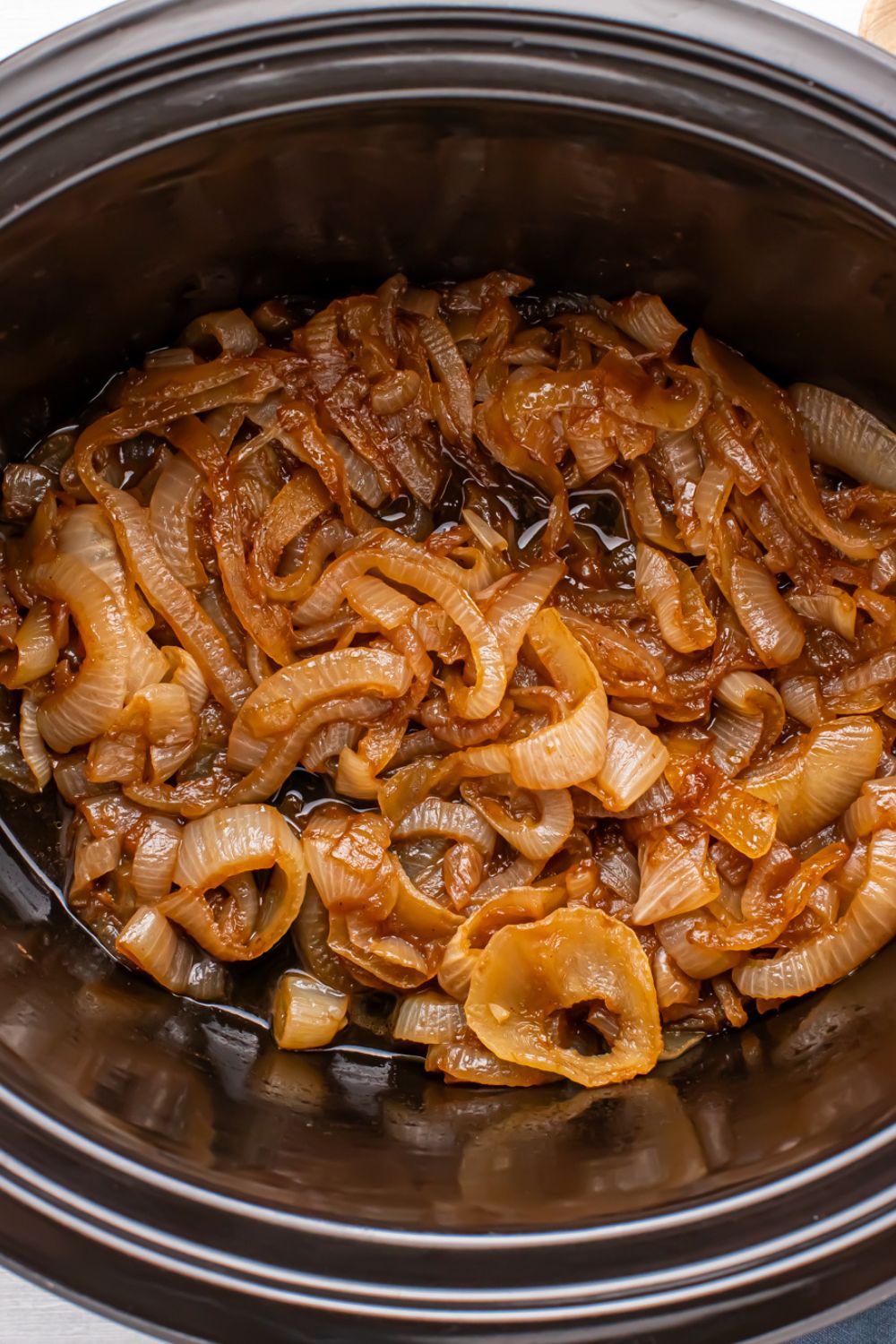 crockpot with caramelized onions in it sitting on a table