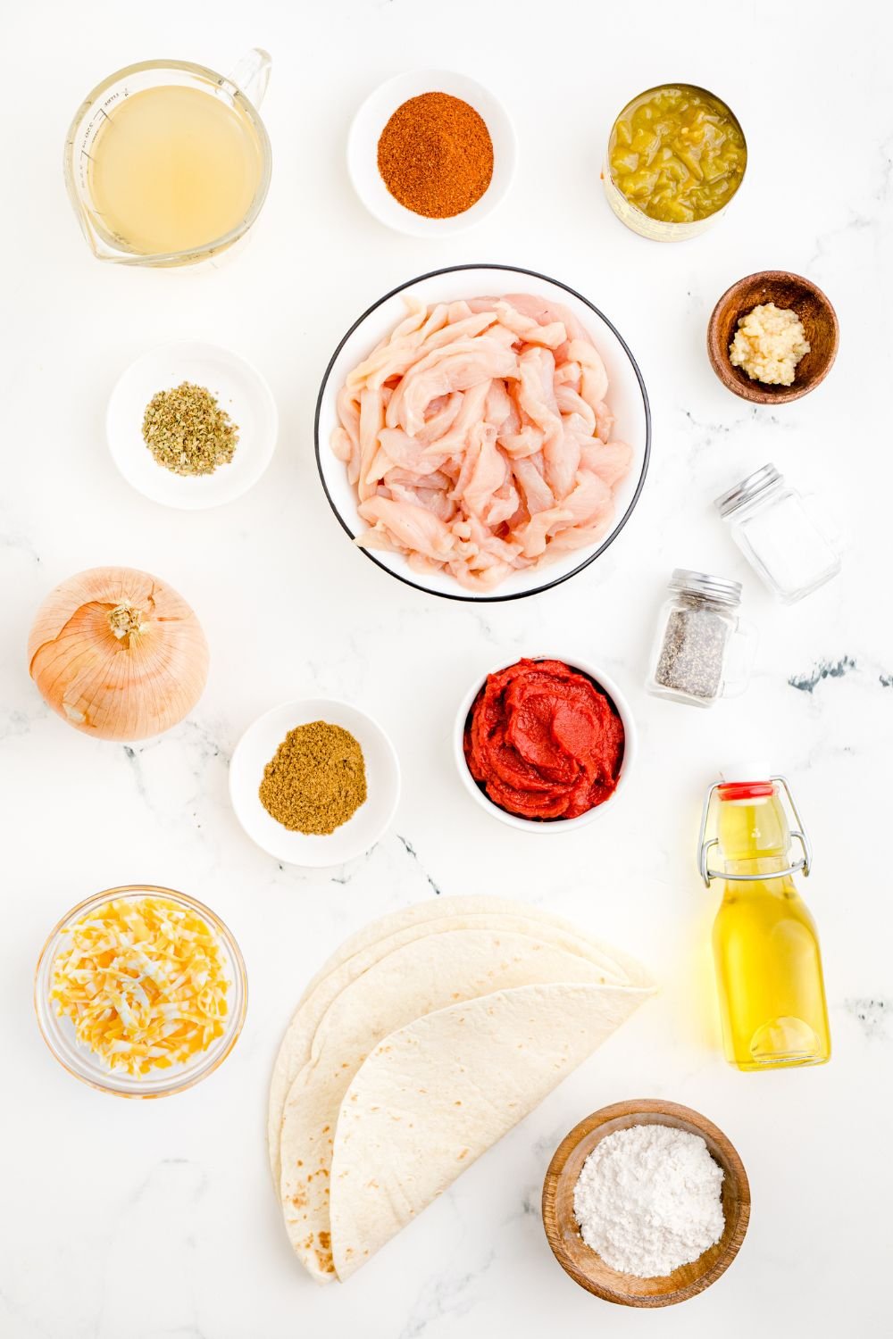 ingredients for Cheesy Chicken Enchiladas in single serve bowls on table 