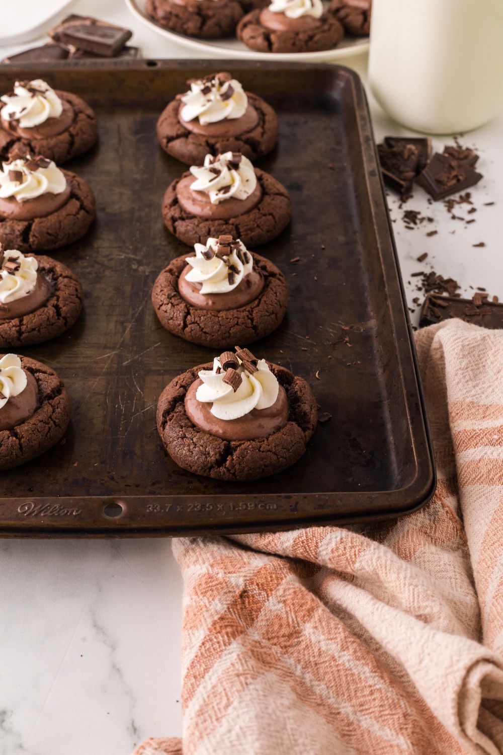 Chocolate Pie Cookies on a cookie tray with chocolate shavings to the side 