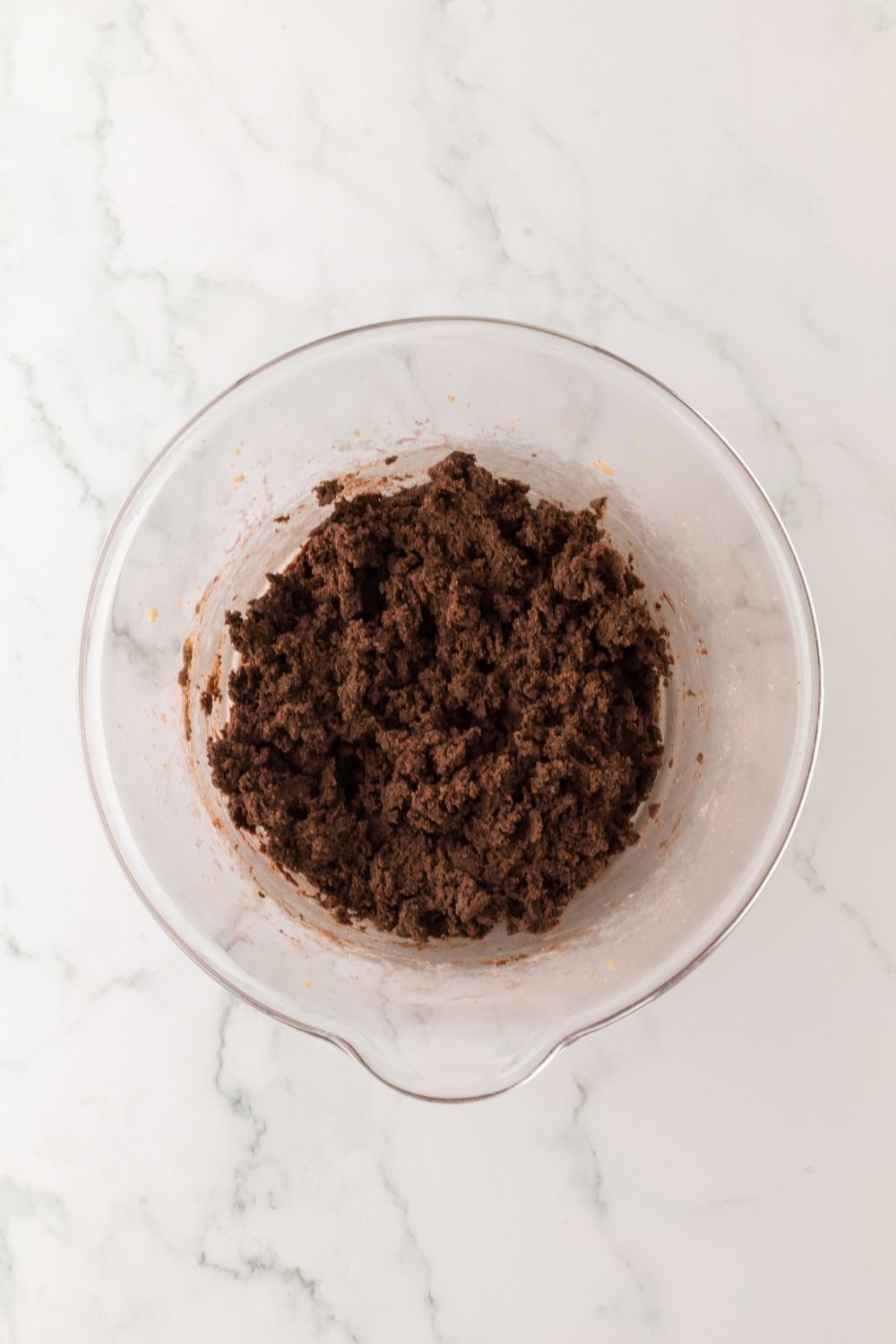 bowl of chocolate cookie batter sitting on table 
