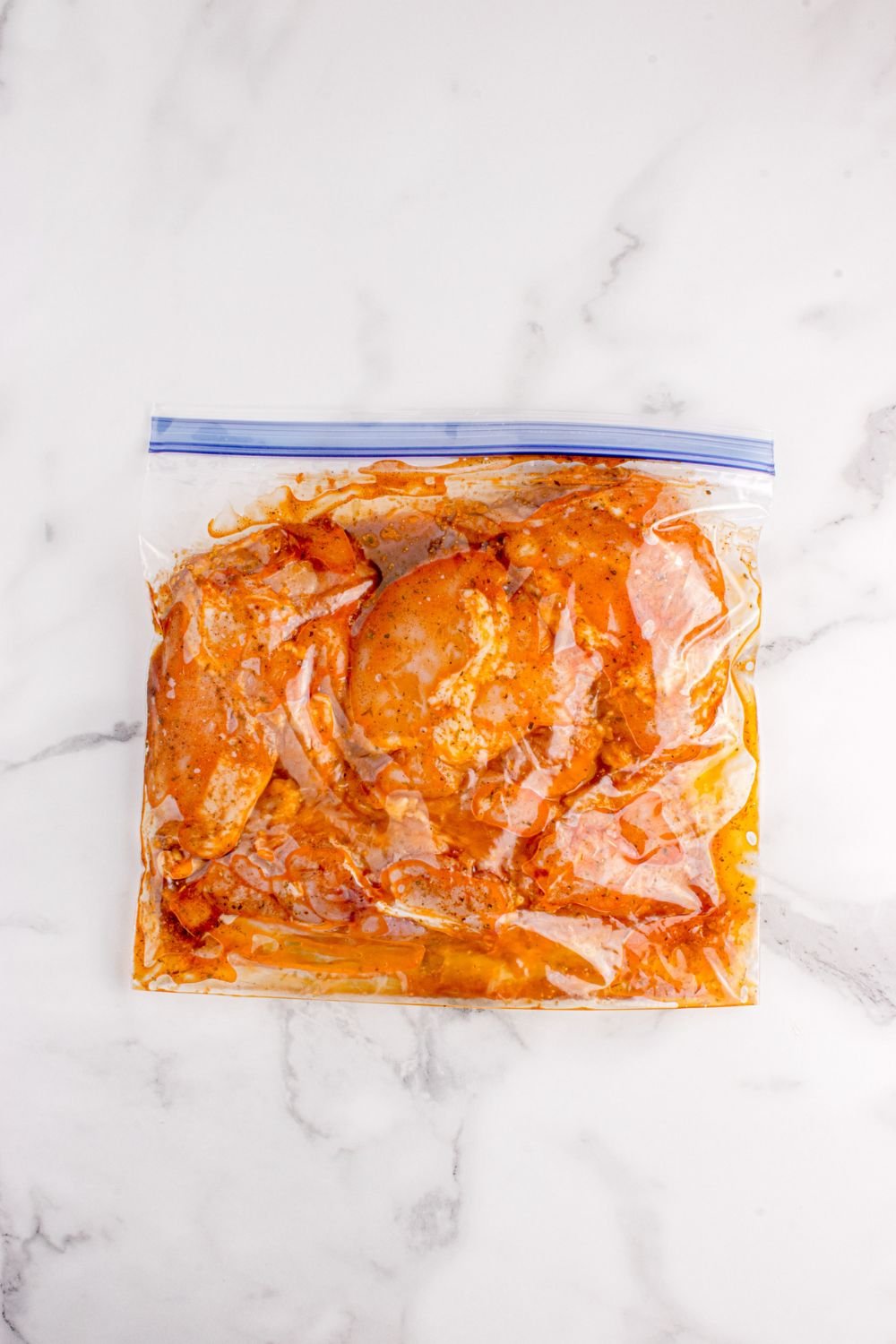 marinated chicken in a bag on table 