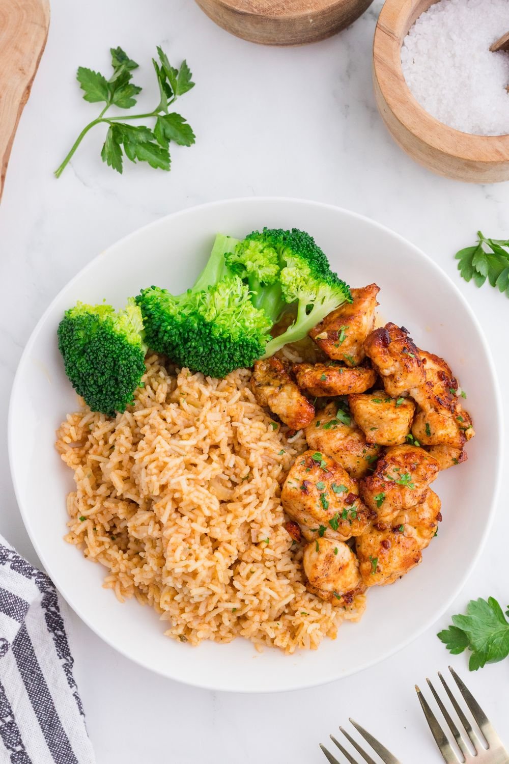 overhead look of plate with Garlic Butter Chicken Bites on it with salt and pepper to the side 