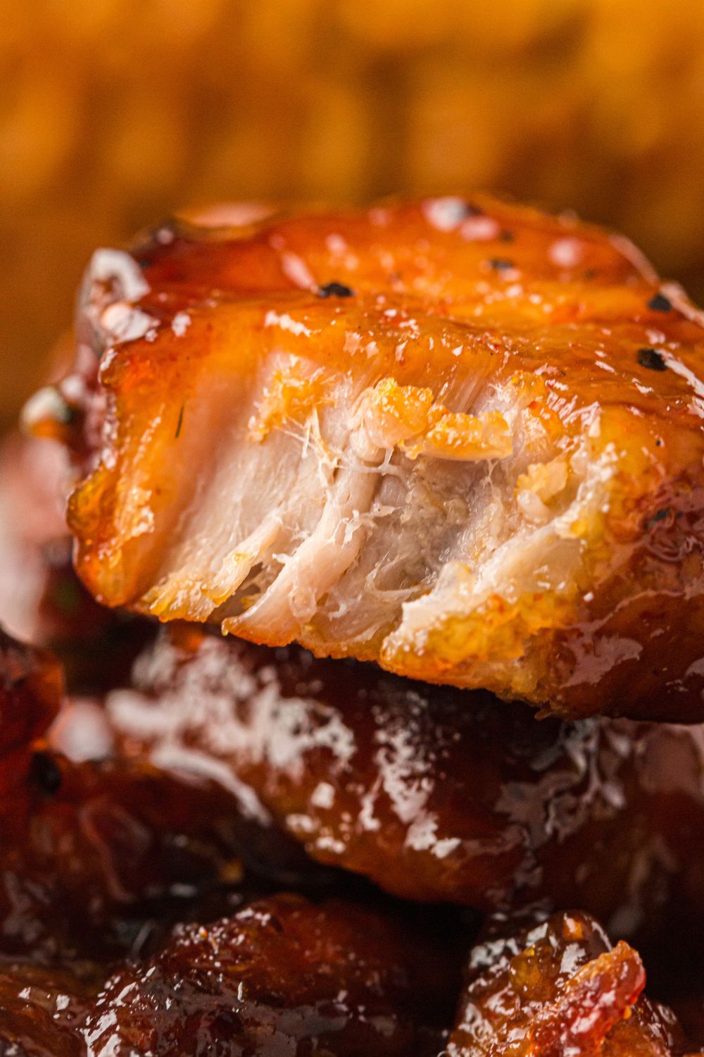 smoked pork belly chunk that is bit in half to show the juicy meat