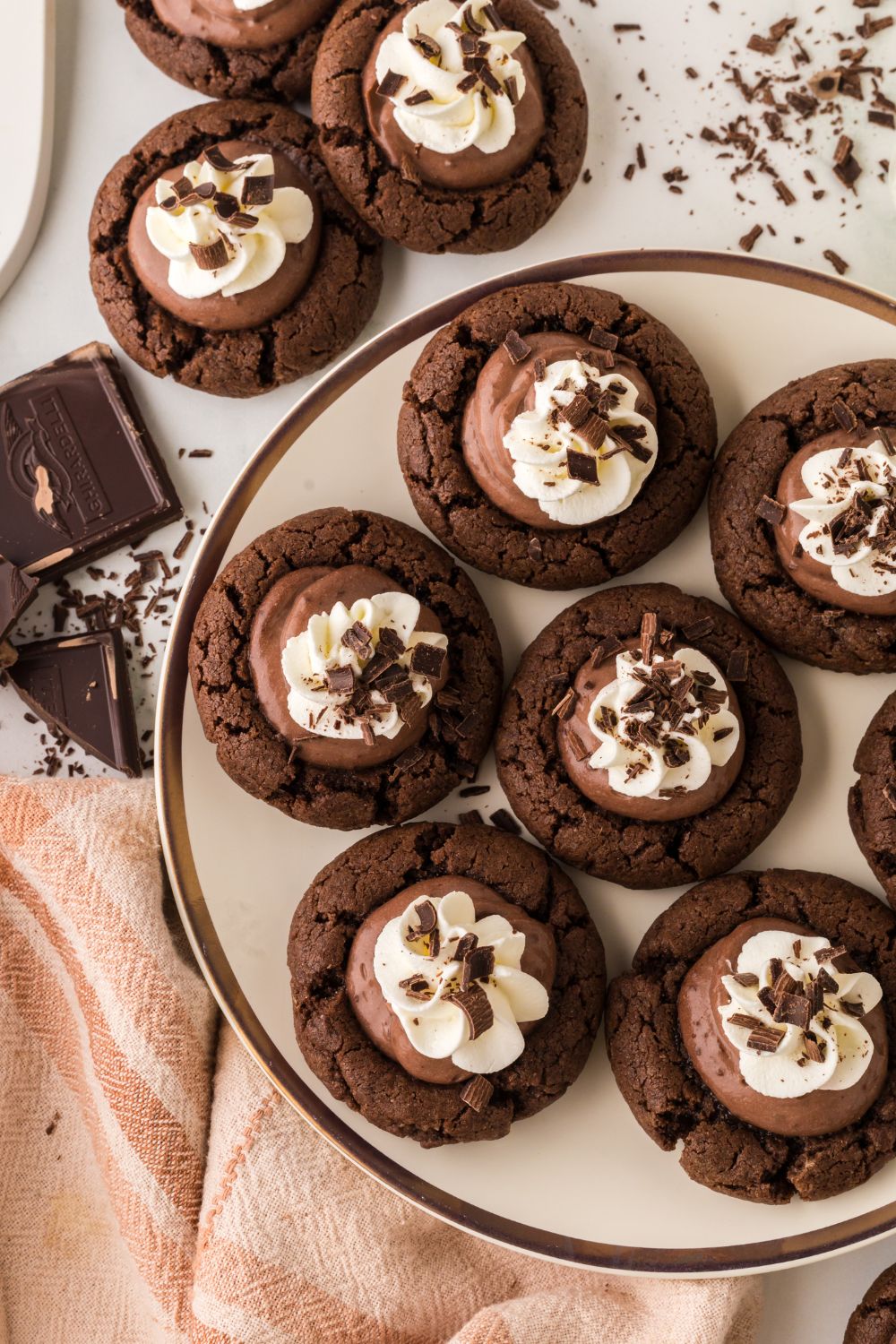 Chocolate Pie Cookies on a plate with more cookies around the table and chocolate shavings 