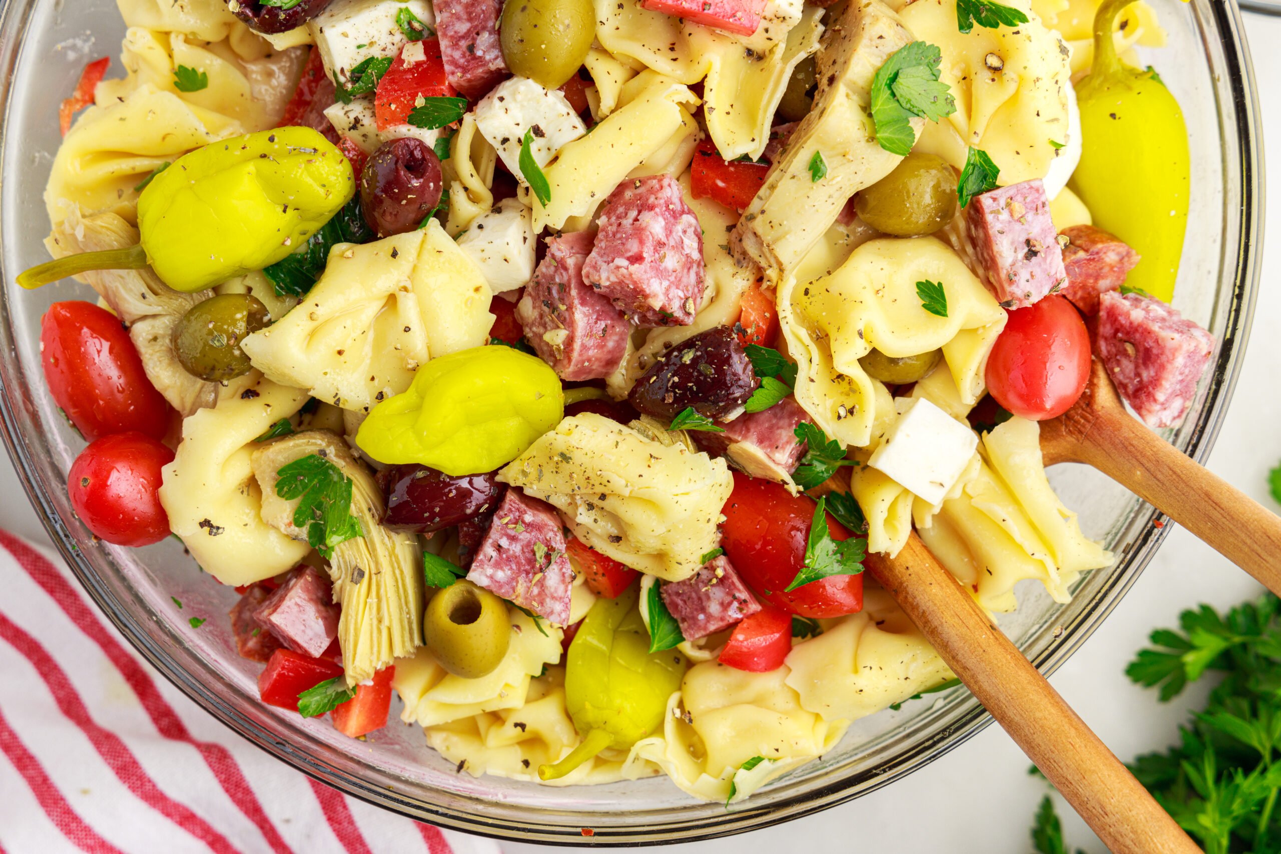 overhead shot of the Antipasto Tortellini Pasta Salad in a glass serving bowl 
