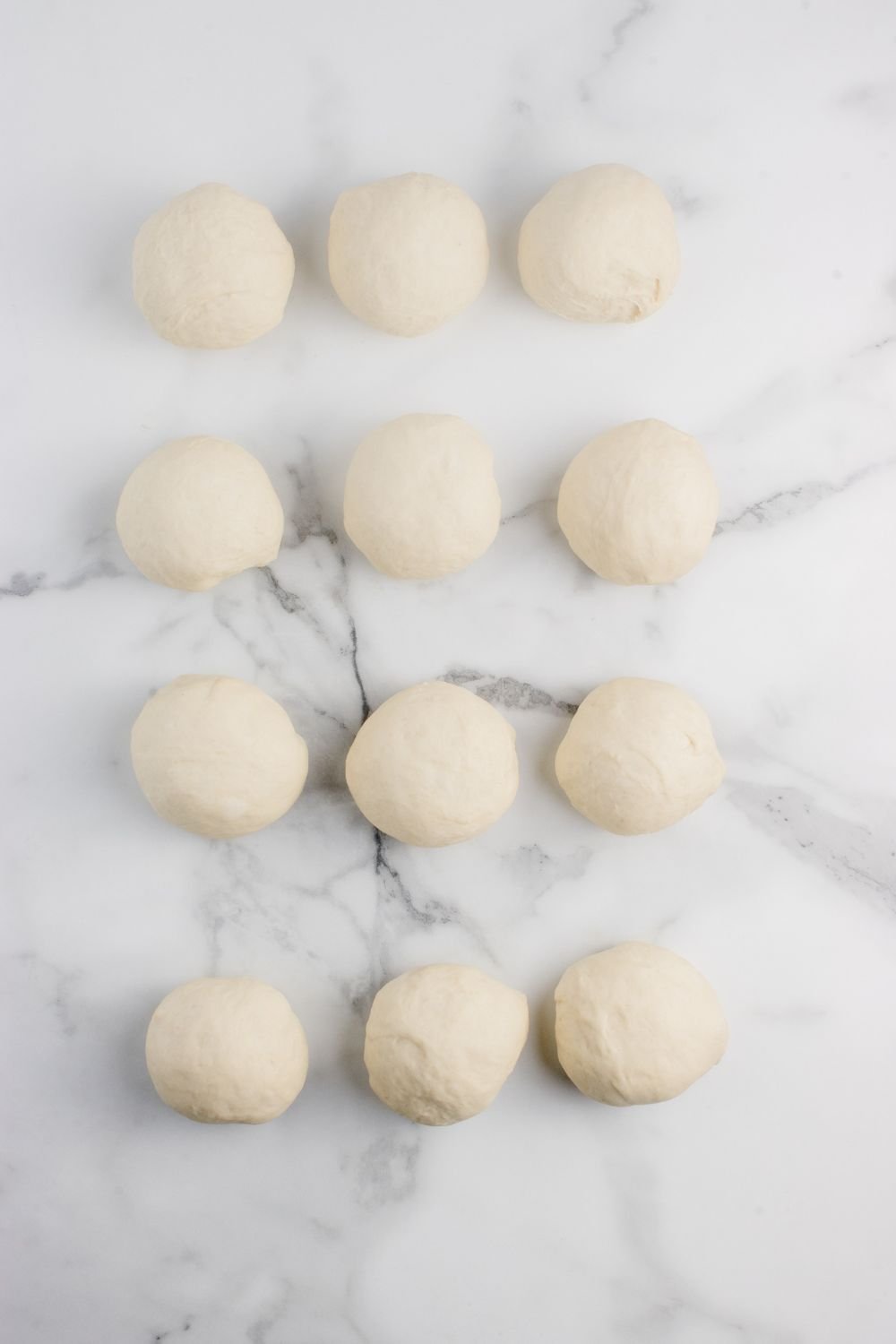 12 dough balls rolled in circles on table 