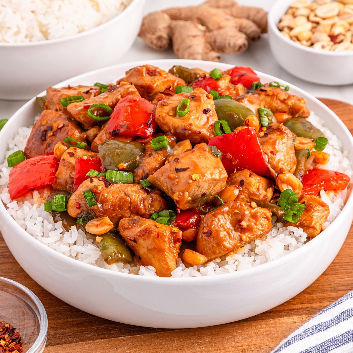 Better Than Takeout Kung Pao Chicken  in a bowl with rice under it 