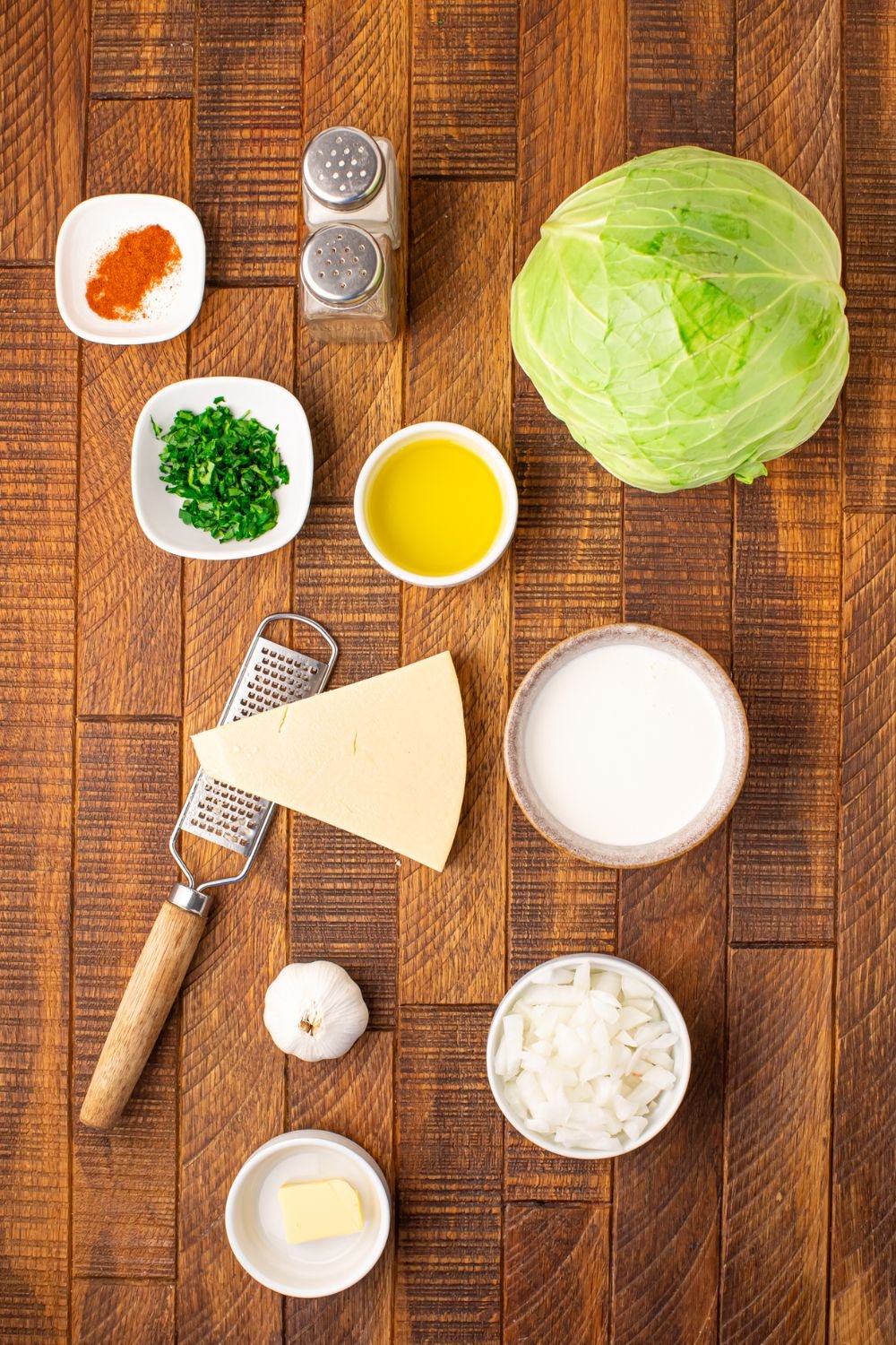 ingredients for Creamy Garlic Parmesan Cabbage on table in single serve containers to show all the ingredients in recipe 