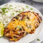 Cheesy Salsa Chicken on plate with rice and lime