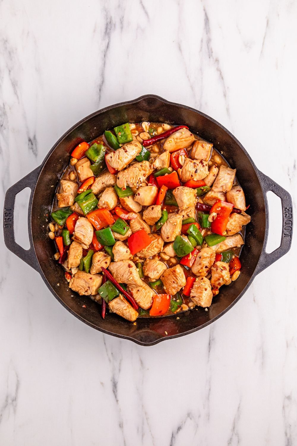 Better Than Takeout Kung Pao Chicken in a cast iron skillet on table 