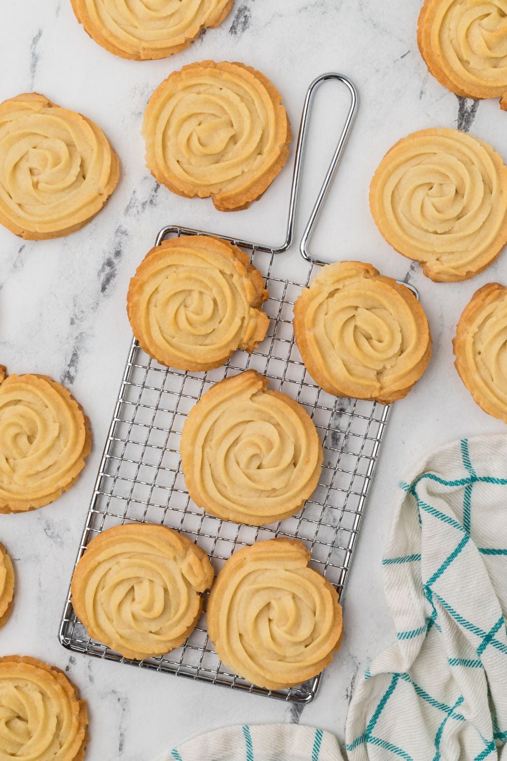 Butter Cookies on cooling rack and more sitting around table 