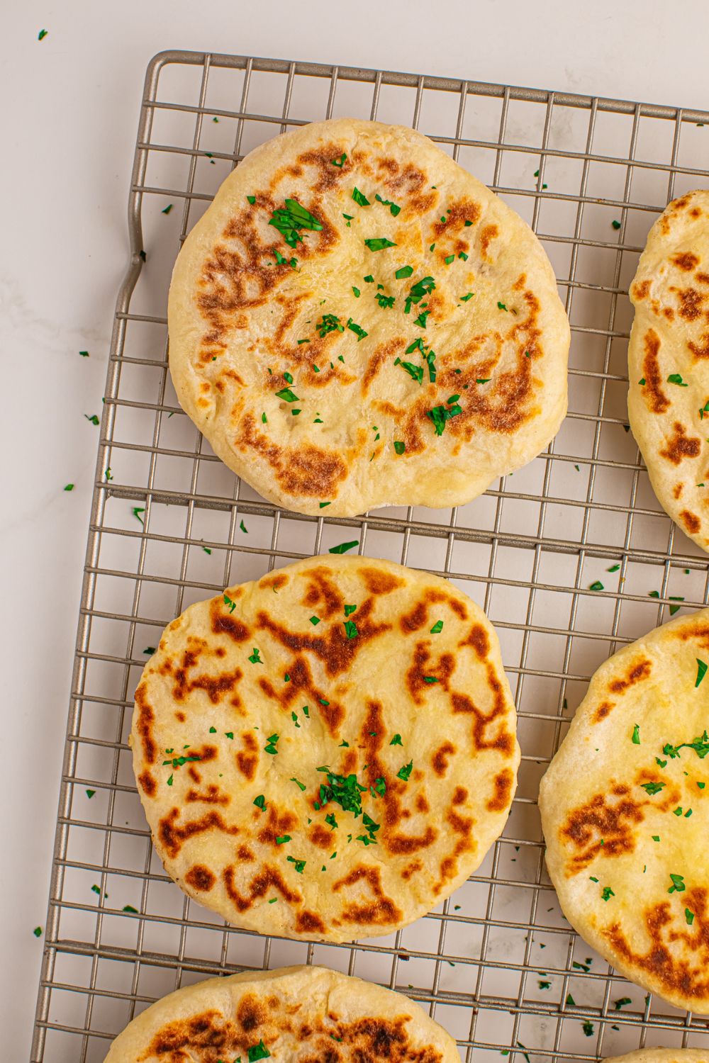 3 Ingredient Flatbread spread out on cooling rack on table 