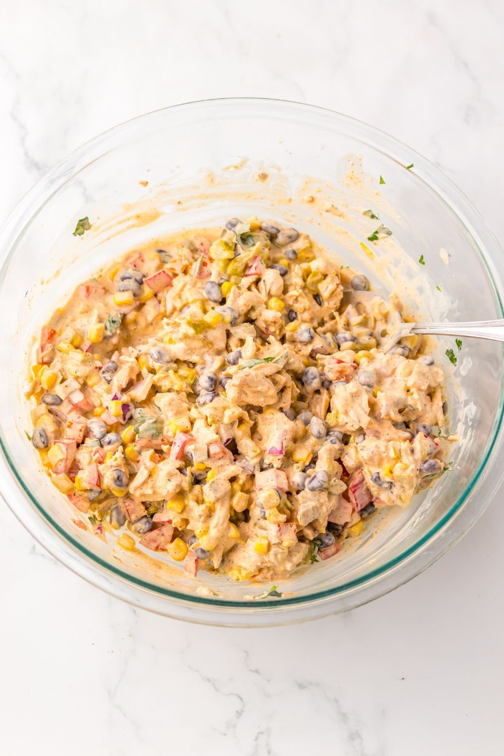 Creamy Taco Chicken Salad  in a glass bowl mixed up 