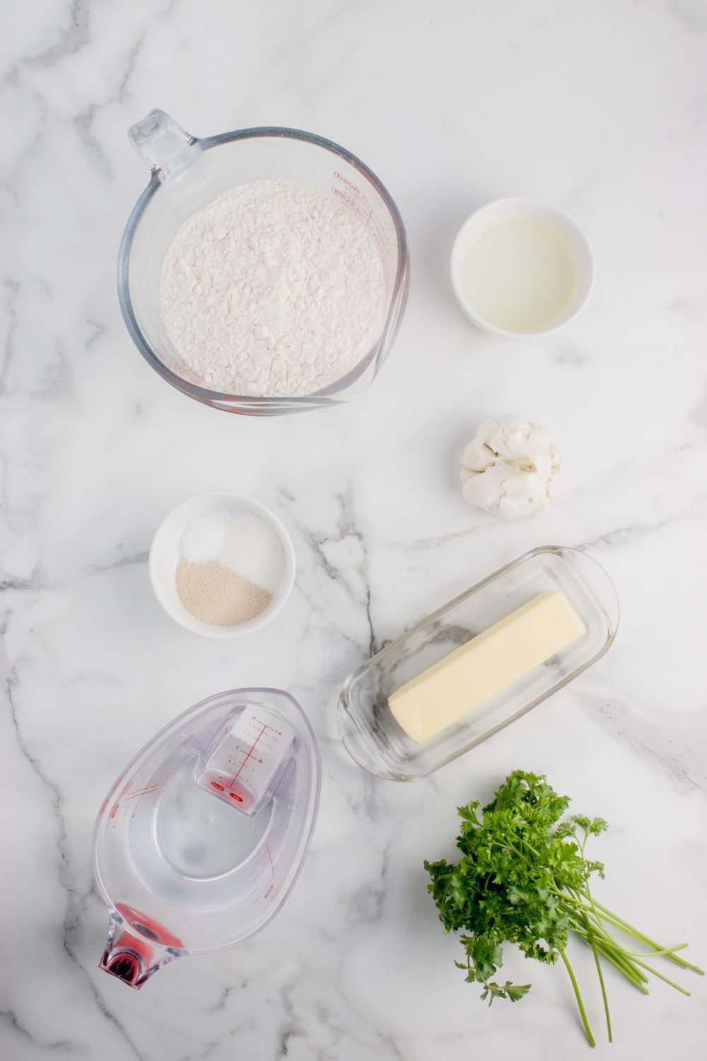 Homemade Garlic Knots ingredients in single serve bowls on table 