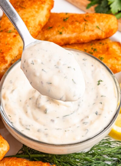 Easy Homemade Tartar Sauce (Better Than Store-Bought!) in a glass serving bowl with a spoon lifting some up