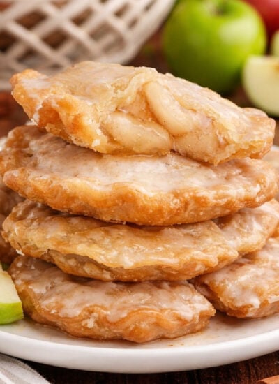 Deep Fried Apple Hand Pies on a white plate stacked